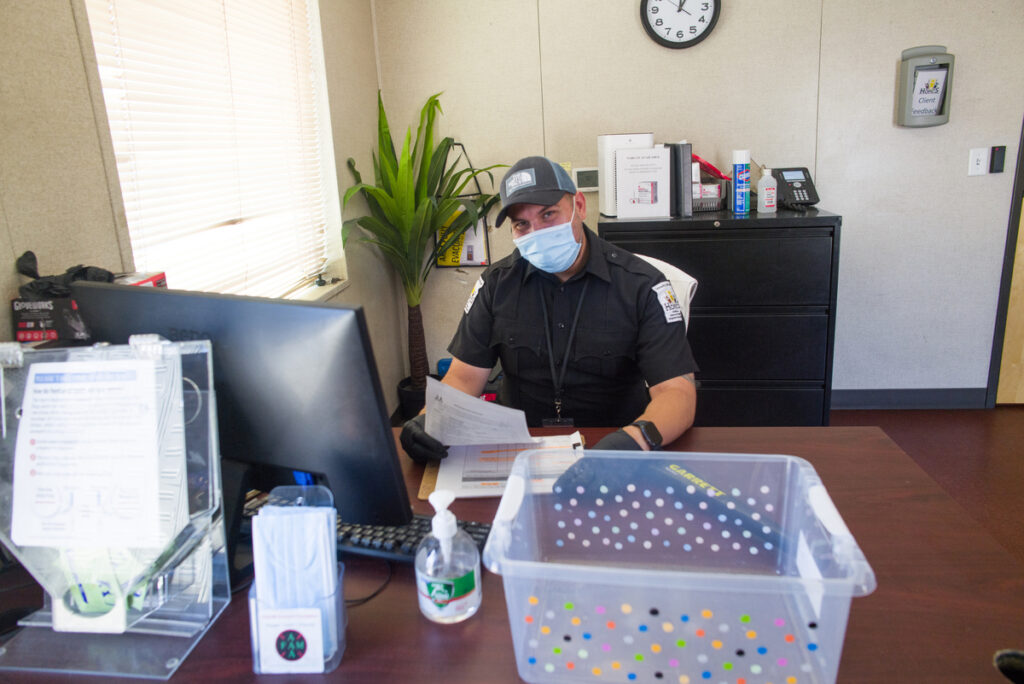 man at a desk with a mask